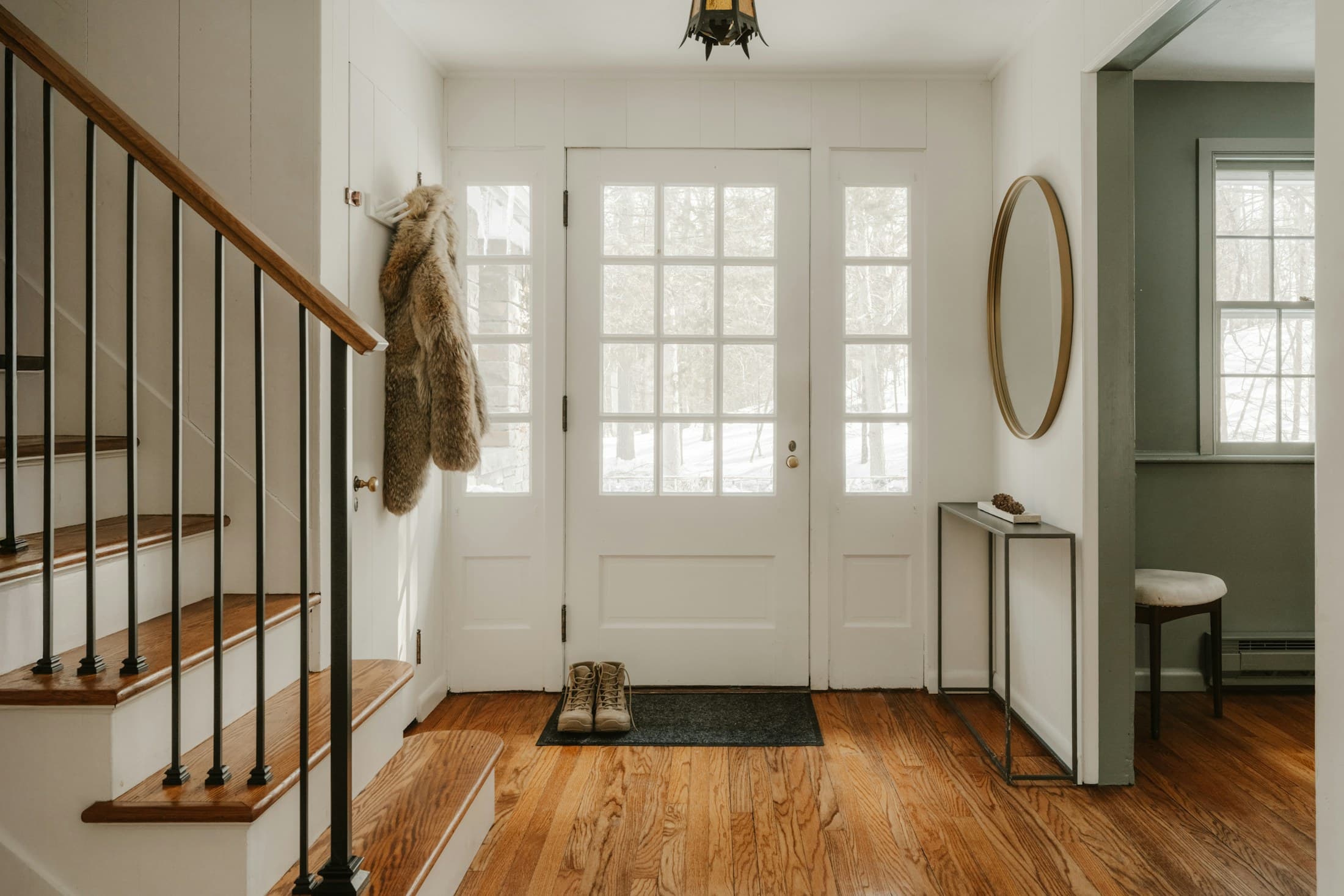 A calm entryway with a door, wall storage, and a narrow surface for everyday arrivals.